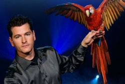 Greg Frewin with a parrot